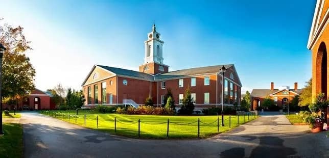 Historic brick building with a tower on the Bentley University campus